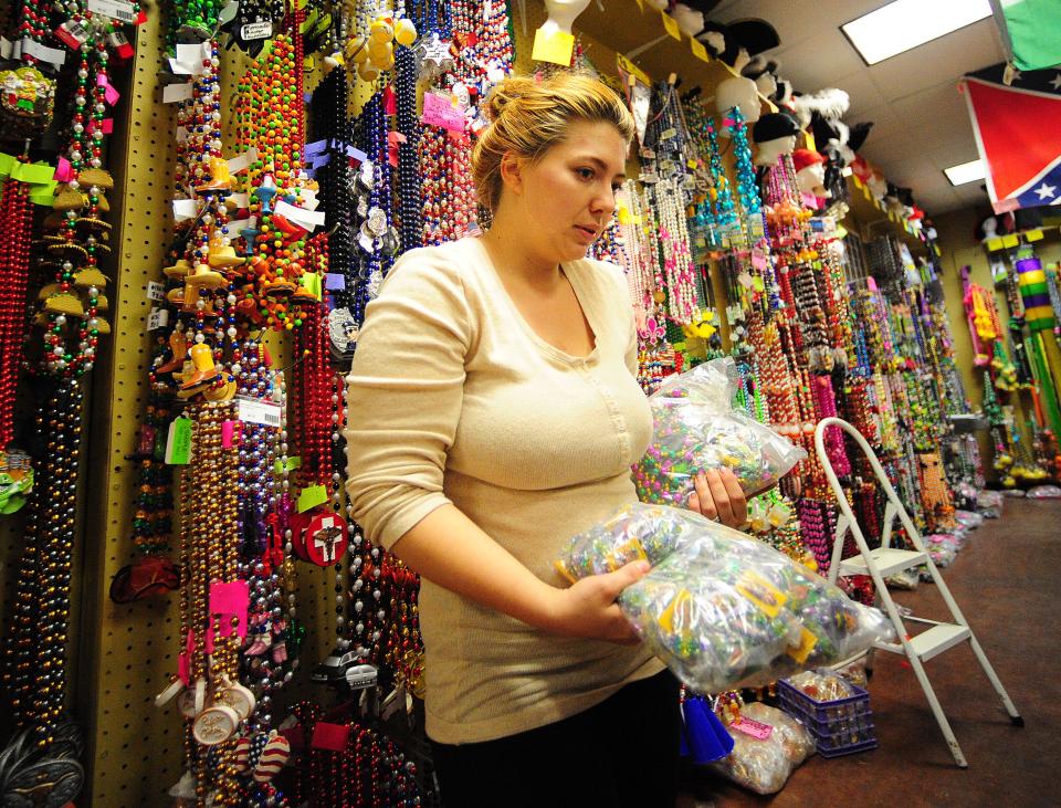 Store manager Megan Trahan sorts and stocks Mardi Gras beads at Beads Galore in Lafayette, Louisiana on  Feb. 5, 2014.