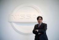 Nissan Executive Vice President Hideyuki Sakamoto poses with the carmaker's logo in the showroom at the carmaker's headquarters in Yokohama, Japan, January 13, 2017. Picture taken January 13, 2017. REUTERS/Toru Hanai