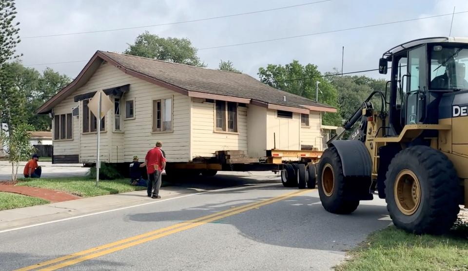 A crew moves the historic house from the southern bank of Crane Creek in May 2020.