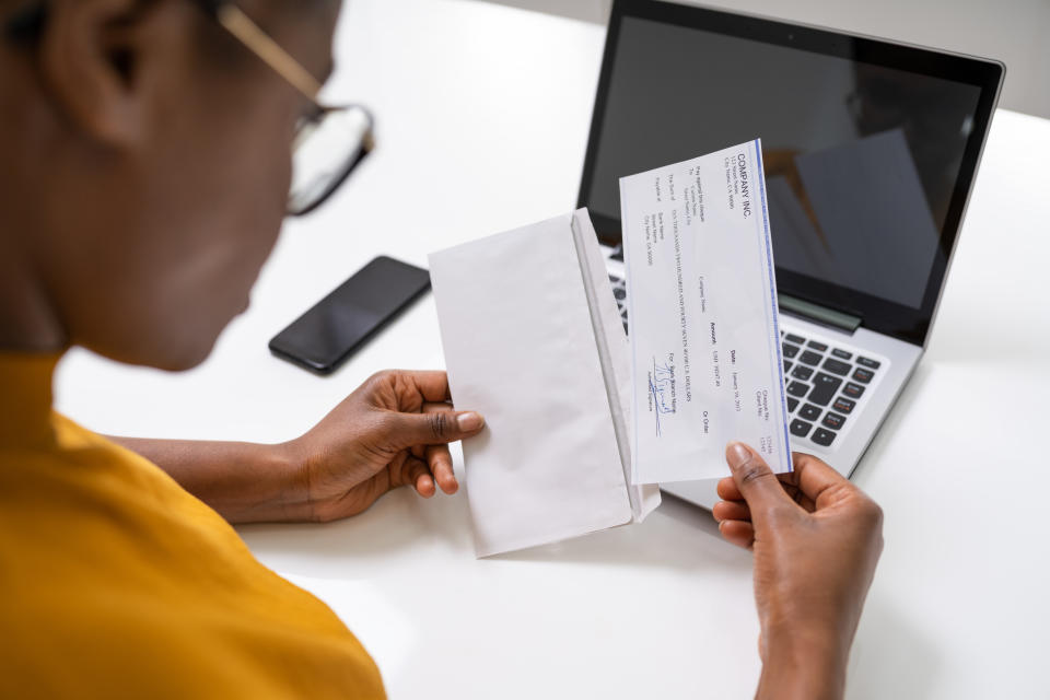 American African Holding Paycheck Or Payroll Check