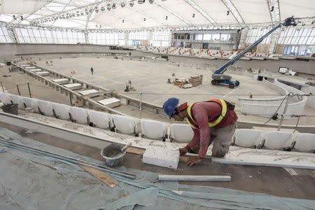 A labourer works on the construction of the Velodrome track, ahead of the 2018 Asian Games in Jakarta, Indonesia March 5, 2018 in this photo taken by Antara Foto. Picture taken March 5, 2018. Antara Foto/Muhammad Adimaja via REUTERS