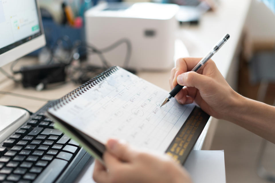 person writing on calendar