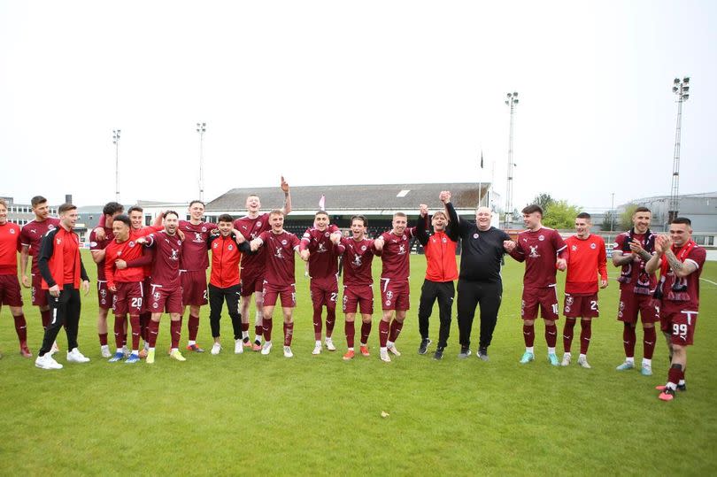 Clyde players celebrate staying up in League Two -Credit:Clyde FC