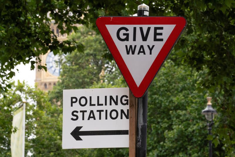 Polling station direction sign is seen ahead of general elections