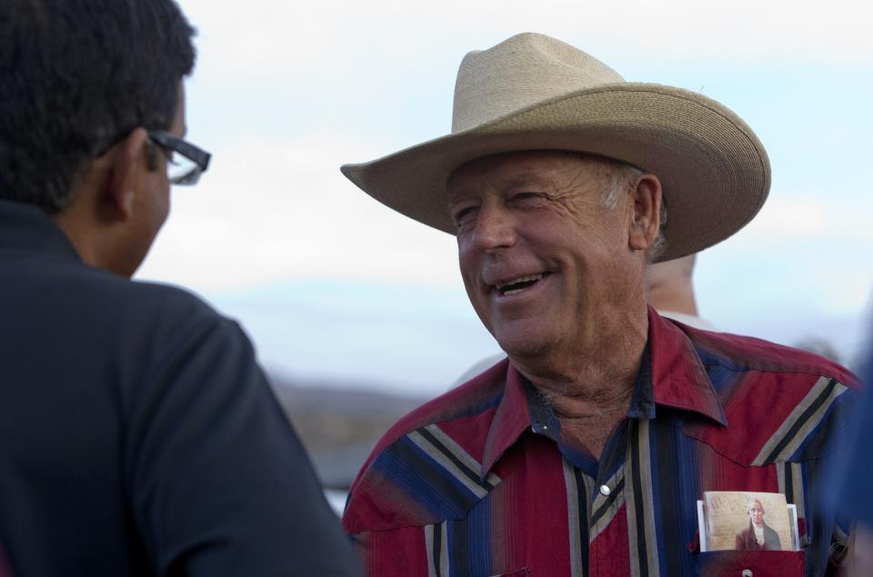 Rancher Cliven Bundy (R) greets a supporter during a Bundy family "Patriot Party" near Bunkerville, Nevada, April 18, 2014. The family organized the party to thank people who supported Bundy in his dispute with the Bureau of Land Management (BLM). The BLM last week called off an effort to round up Bundy's herd of cattle that it said were being illegally grazed in southern Nevada, citing concerns about safety. (REUTERS/Steve Marcus)