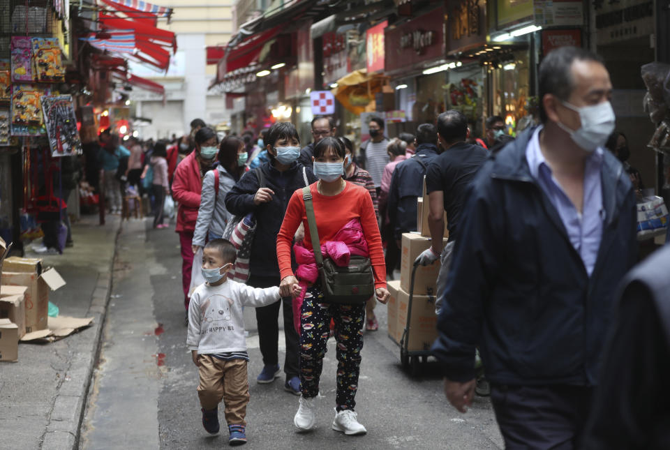 People visit the open market wearing face masks in hopes to prevent contracting the spreading coronavirus in Hong Kong, Monday, Feb, 3, 2020. In Hong Kong, thousands of health care workers were threatening to go on strike Tuesday unless the government agrees to talks before a 6 p.m. Monday deadline. Hong Kong has recorded 14 cases of the virus and has cut flights and train and bus connections to the mainland, but a push is growing for the semi-autonomous Chinese city to close the border completely. (AP Photo/Achmad Ibrahim)