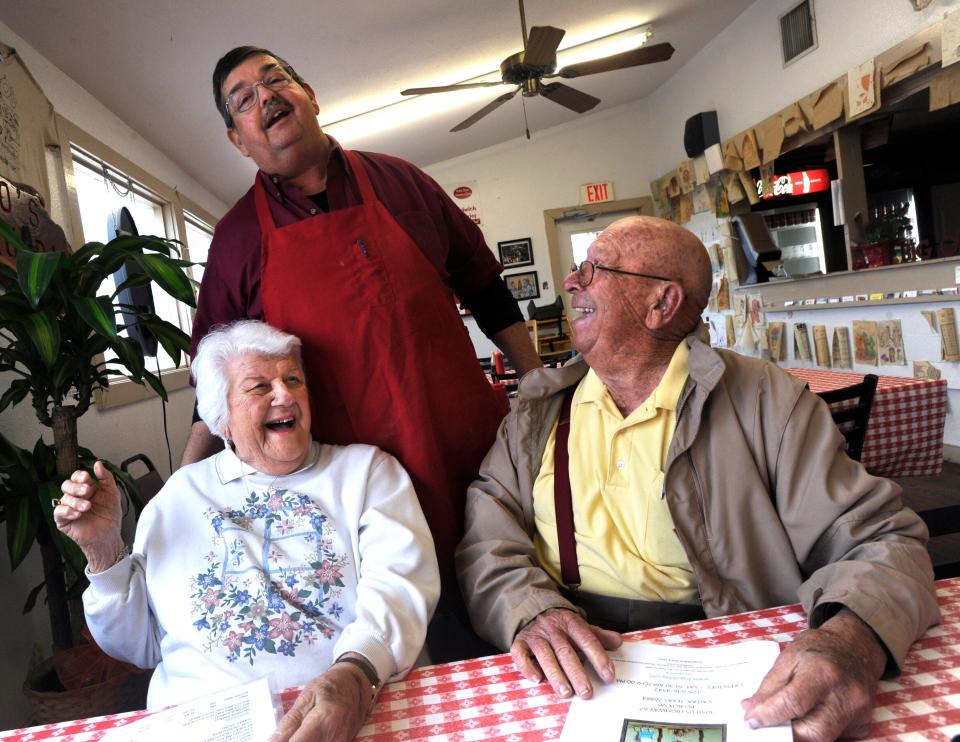 Lynn Owens jokes with June and Wes Hays who came to celebrate their 70th wedding anniversary at his Big O’s Restaurant April 3, 2013. Owens counted many of his customers as also friends.
