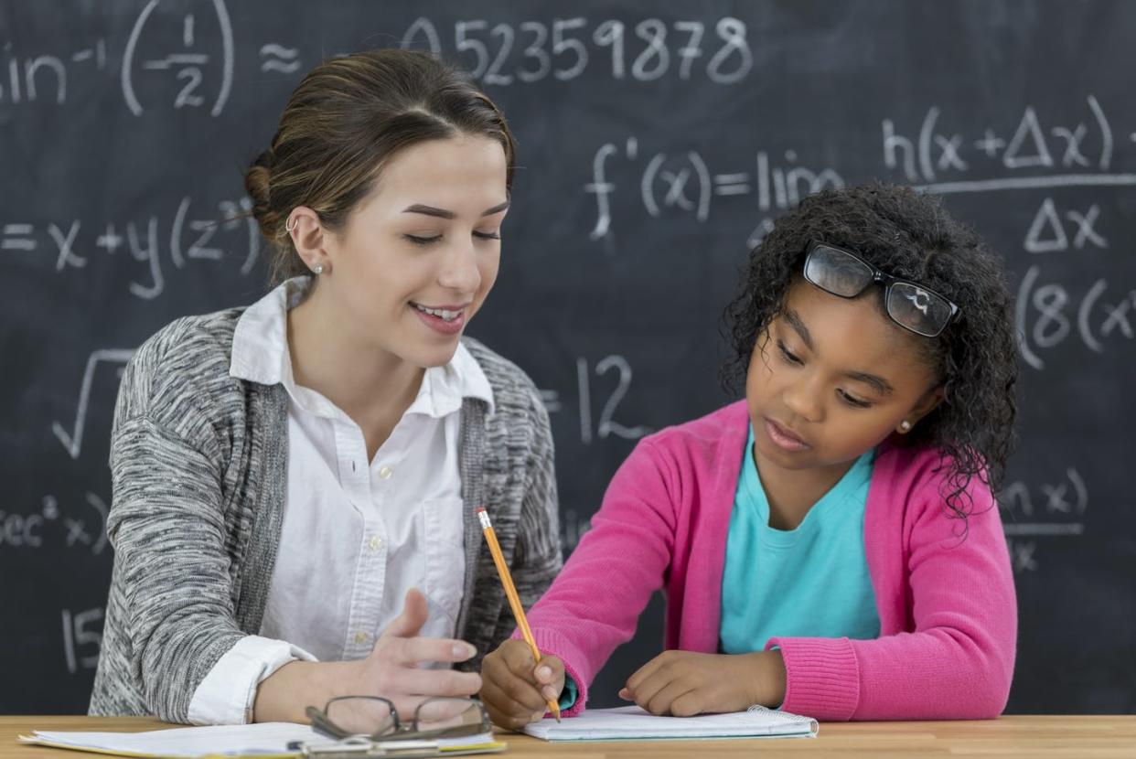 <span class="caption">Affluent students also benefited more from gifted programs compared to students from low-income backgrounds.</span> <span class="attribution"><a class="link " href="https://www.gettyimages.com/detail/photo/math-teacher-helps-elementary-schoolgirl-with-math-royalty-free-image/642372236?adppopup=true" rel="nofollow noopener" target="_blank" data-ylk="slk:SDI Productions/E+ via Getty Images;elm:context_link;itc:0;sec:content-canvas">SDI Productions/E+ via Getty Images</a></span>