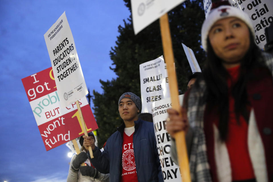 Striking teachers and supporters walk a picket line outside Lane Tech High School, in Chicago, on the first day of a strike by the Chicago Teachers Union, Thursday, Oct. 17, 2019. (Jose M. Osorio/Chicago Tribune via AP)