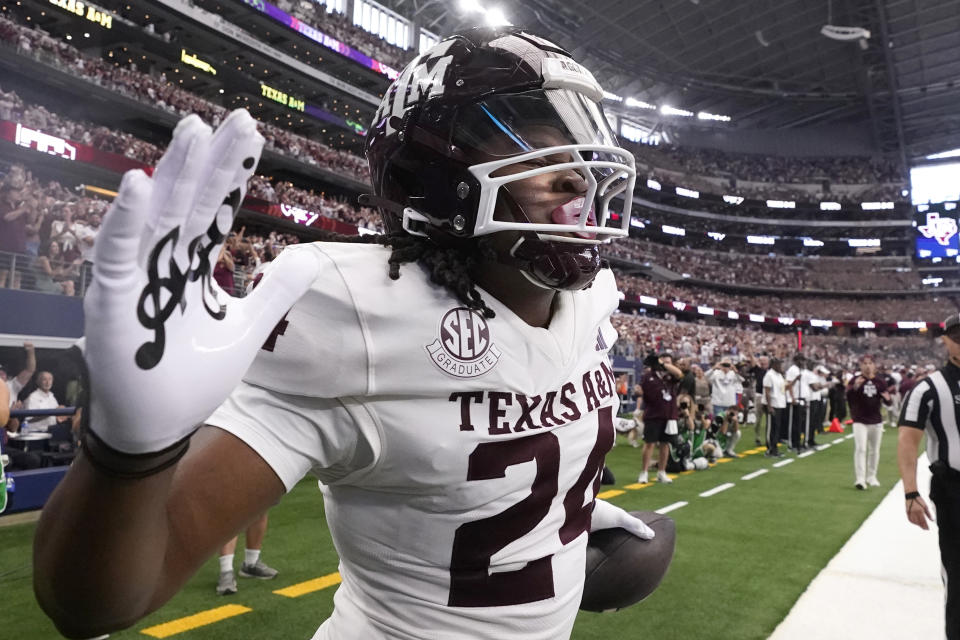 Texas A&M running back Earnest Crownover (24) celebrates after scoring a touchdown during the first half of an NCAA college football game against Arkansas, Saturday, Sept. 30, 2023, in Arlington, Texas. (AP Photo/LM Otero)