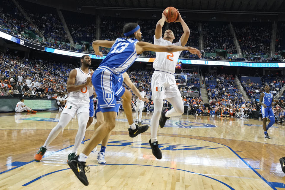 Miami guard Harlond Beverly (5) shoots against Duke guard Jacob Grandison (13) during the first half of an NCAA college basketball game at the Atlantic Coast Conference Tournament in Greensboro, N.C., Friday, March 10, 2023. (AP Photo/Chuck Burton)