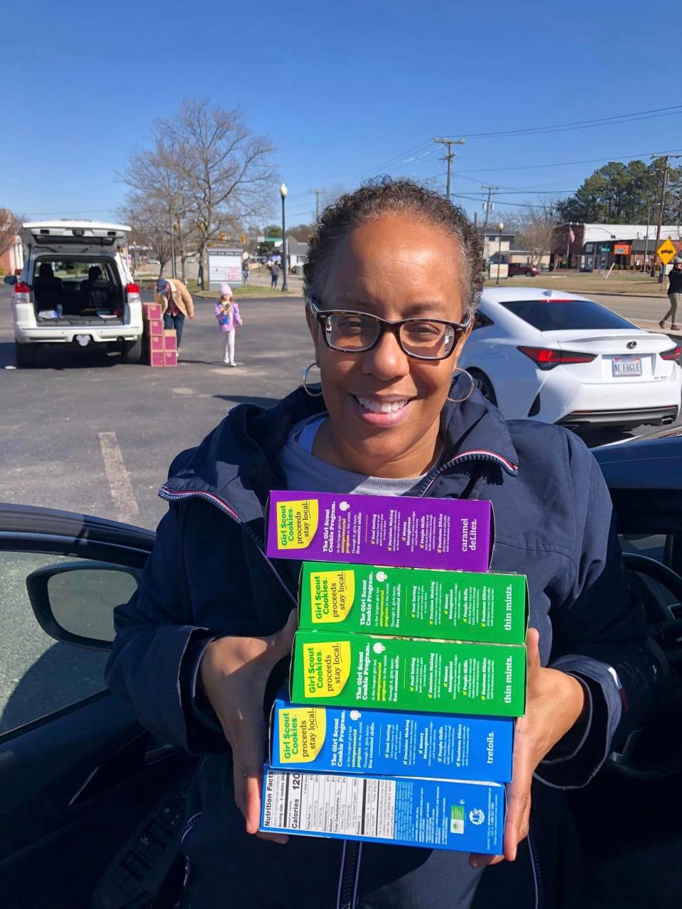 Crystal Scott carries five boxes of Girl Scout Cookies she purchased from a cookie booth in the Chester Village Shopping Center parking lot on Saturday, February 18 in Chester.