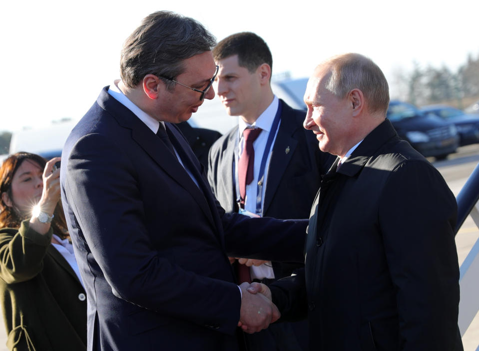 Serbian President Aleksandar Vucic, left, greets Russian President Vladimir Putin upon his arrival at the Belgrade's Nikola Tesla Airport, Serbia, Thursday, Jan. 17, 2019. Putin arrives in Serbia on Thursday for his fourth visit to the Balkan country since 2001. (Mikhail Klimentyev, Sputnik, Kremlin Pool Photo via AP)