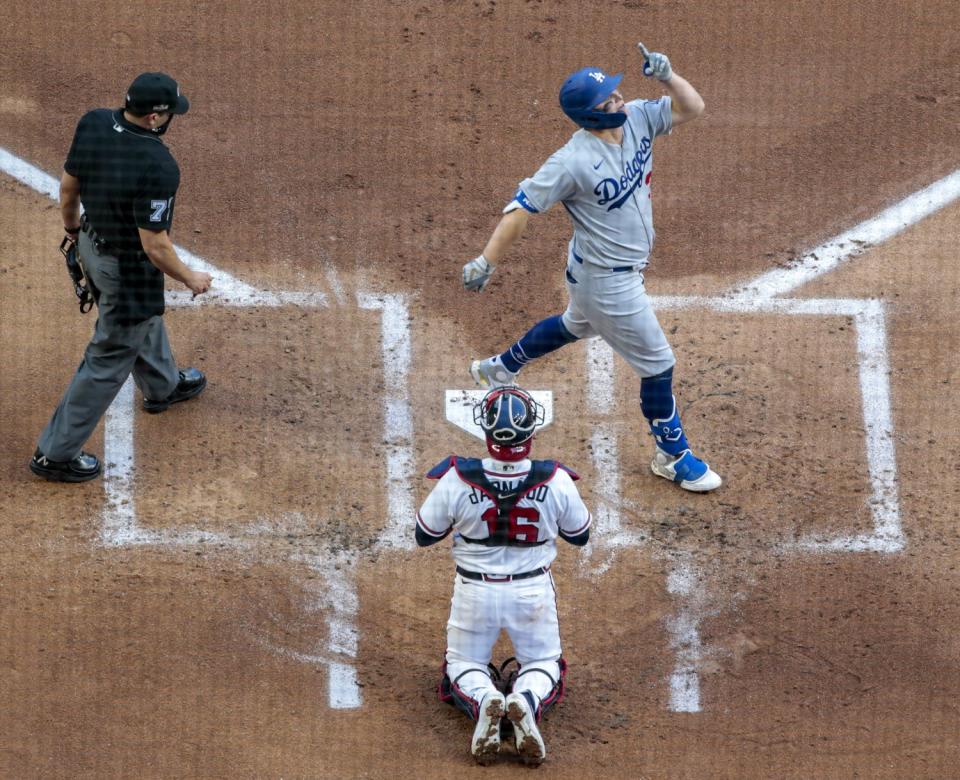 Joc Pederson crosses home plate after hitting a three-run home run against the Atlanta Braves.