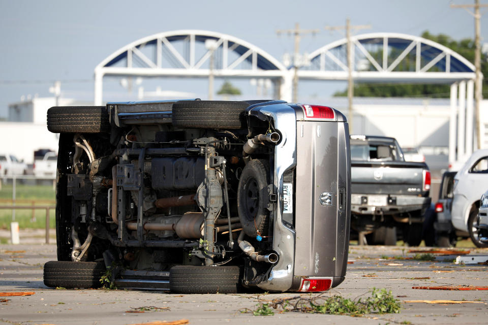 A truck lies on its side at Frontier Car Dealership in El Reno, Okla., on May 26, after a tornado touched down. (Photo: Alonzo Adams/Reuters)