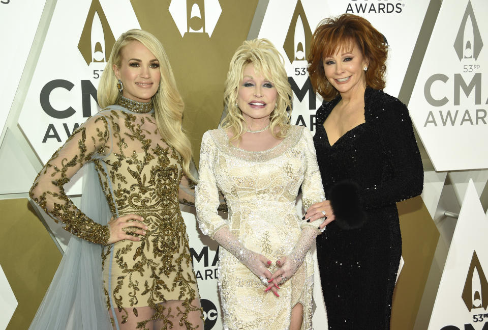 Carrie Underwood, from left, Dolly Parton, and Reba McEntire arrive at the 53rd annual CMA Awards at Bridgestone Arena on Wednesday, Nov. 13, 2019, in Nashville, Tenn. (Photo by Evan Agostini/Invision/AP)