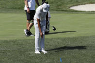 Tony Finau takes a drop after hitting his shot into the water from the 14th tee during the third round of the Memorial golf tournament, Saturday, July 18, 2020, in Dublin, Ohio. (AP Photo/Darron Cummings)