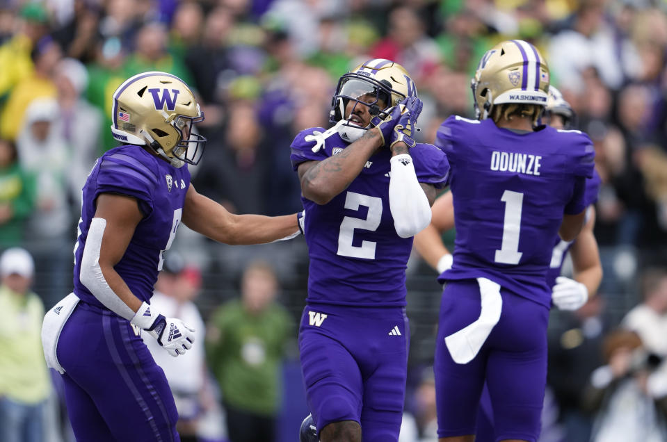 Washington wide receiver Ja'Lynn Polk (2) reacts with Will Nixon, left, after scoring a touchdown against Oregon during the first half of an NCAA college football game Saturday, Oct. 14, 2023, in Seattle. (AP Photo/Lindsey Wasson)