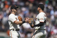 San Francisco Giants' Evan Longoria, left, celebrates with Wilmer Flores after the Giants defeated the New York Mets in a baseball game in San Francisco, Wednesday, May 25, 2022. (AP Photo/Jeff Chiu)