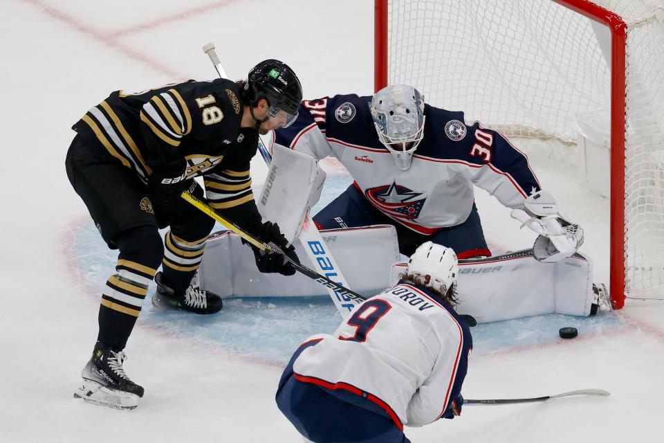 Columbus Blue Jackets goaltender Spencer Martin (30) makes a pad-save on a shot-attempt by Boston Bruins center Pavel Zacha (18) during the first period of an NHL hockey game, Sunday, Dec. 3, 2023, in Boston. (AP Photo/Mary Schwalm)