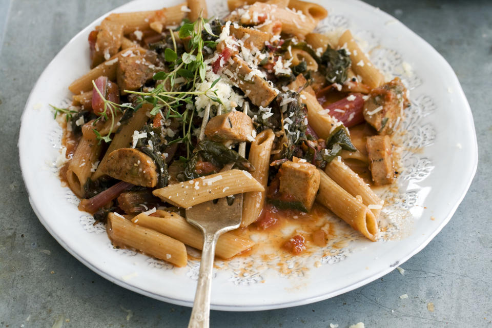 In this image taken on April 15, 2013, whole-wheat penne with spring greens and sausage is shown served on a plate in Concord, N.H. (AP Photo/Matthew Mead)