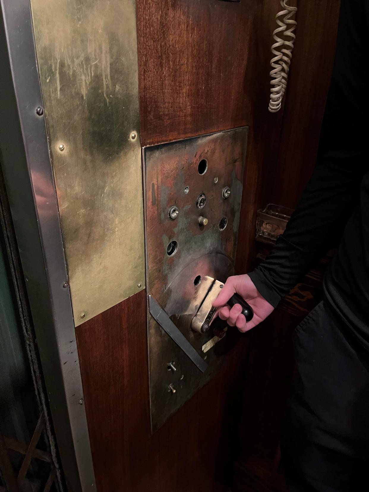 An elevator operator at the Commodore condominiums takes a resident of the 95-year-old building to her unit.