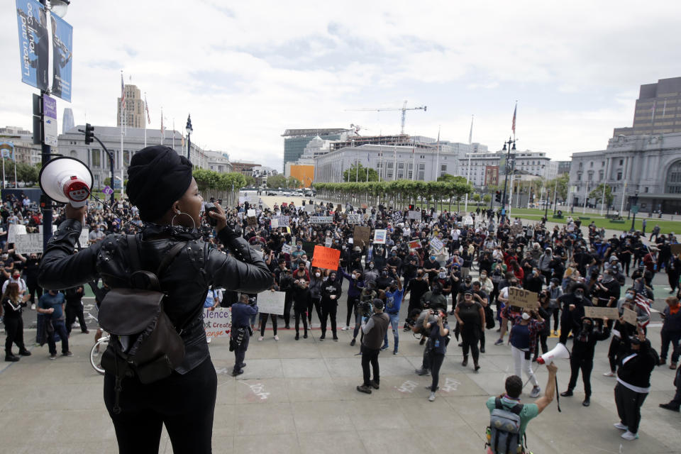 Raiah Sinn, foreground, speaks at a protest over the Memorial Day death of George Floyd, a handcuffed black man in police custody in Minneapolis, in San Francisco, Saturday, May 30, 2020. (AP Photo/Jeff Chiu)
