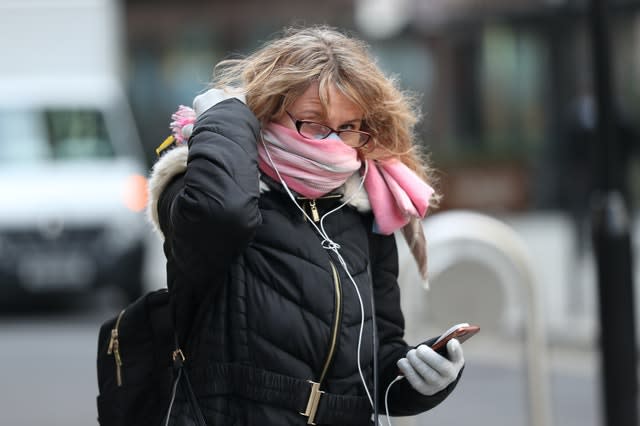 A woman with a scarf covering her mouth an nose