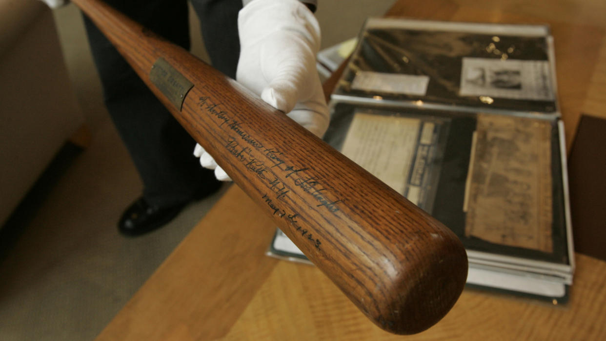 Mandatory Credit: Photo by Julie Jacobson/AP/Shutterstock (6393736a)The bat used by Babe Ruth to hit his first home run in Yankee Stadium in 1923, is held for a photograph at Sotheby's in New York.