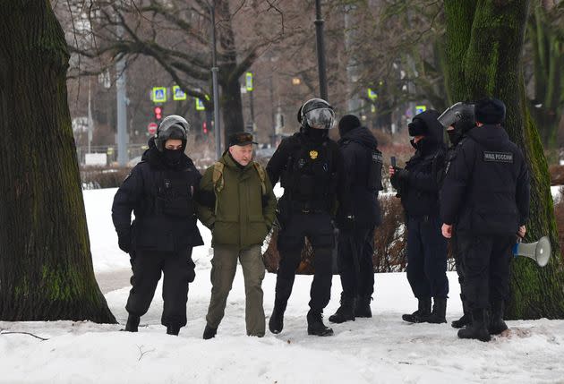 Police officers detain a man as people come to the monument to the victims of political repressions to lay flowers for late Russian opposition leader Alexei Navalny in Saint Petersburg on February 17, 2024, one day after the death of Navalny in an Arctic prison. (Photo by Olga MALTSEVA / AFP) (Photo by OLGA MALTSEVA/AFP via Getty Images)