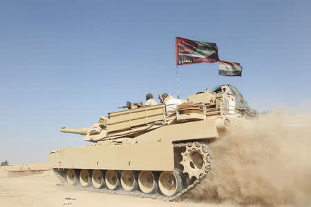 A tank of the Iraqi army drives south of Mosul, Iraq October 30, 2016. REUTERS/Stringer