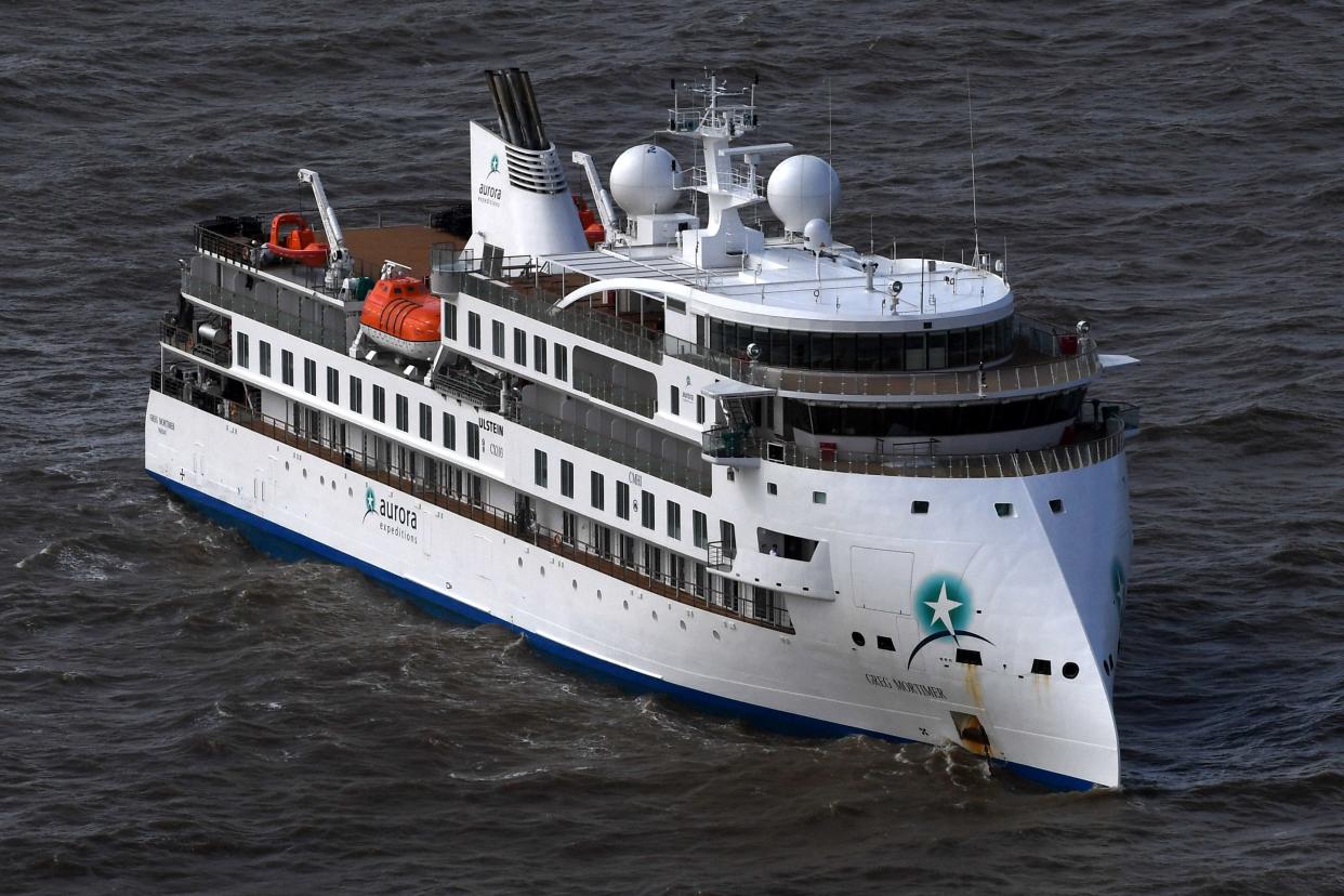 Aerial view of Australian cruise ship Greg Mortimer off the port of Montevideo on April 7, 2020. - Australian and New Zealand passengers on board a cruise ship off the South American coast will be the first flown home in a series of rescue flights as coronavirus on the ship rose sharply Tuesday, according to the Greg Mortimer's operator. Confirmed COVID-19 cases on the ship -  currently anchored in the Rio de la Plata near Uruguay - jumped from 81 to 128 on Tuesday with a medical flight for the Australians onboard expected to begin Thursday. (Photo by PABLO PORCIUNCULA / AFP) (Photo by PABLO PORCIUNCULA/AFP via Getty Images)