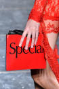 <p>A model carries a “Special” red clutch from the Christopher Kane FW18 show. (Photo: Getty Images) </p>