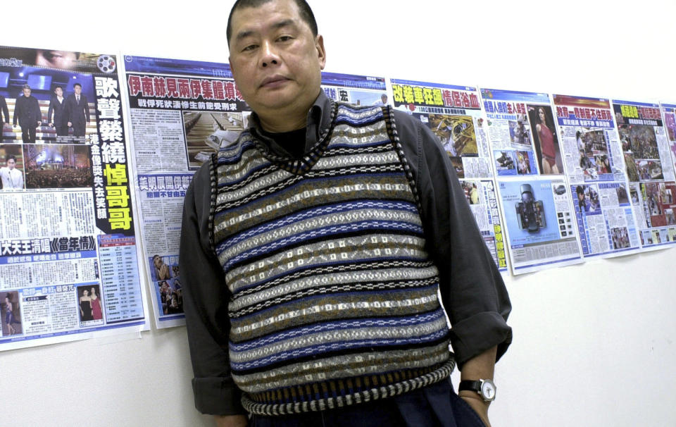 FILE - Jimmy Lai, owner of the Hong Kong newspaper Apple Daily, poses next to dry runs of a soon to be launched Taiwanese newspaper taped to his office wall, April 7, 2003, in Taipei. On Thursday, Feb. 1, 2024, two U.S. lawmakers announced a nomination for Lai, who is now standing trial on national security charges, and three other jailed Chinese dissidents, for the Nobel Peace Prize. While hundreds of people are often nominated for the annual prize, this nomination is certain to draw a sharp rebuke from Beijing. (AP Photo/Jerome Favre, File)