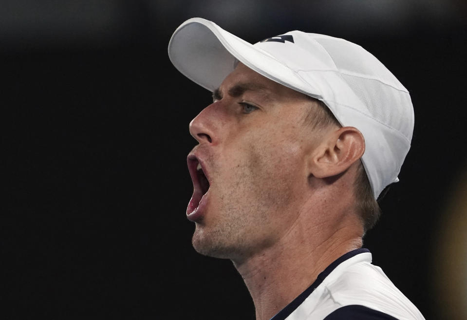 Australia's John Millman yells during this third round singles match against Switzerland's Roger Federer at the Australian Open tennis championship in Melbourne, Australia, Friday, Jan. 24, 2020. (AP Photo/Lee Jin-man)