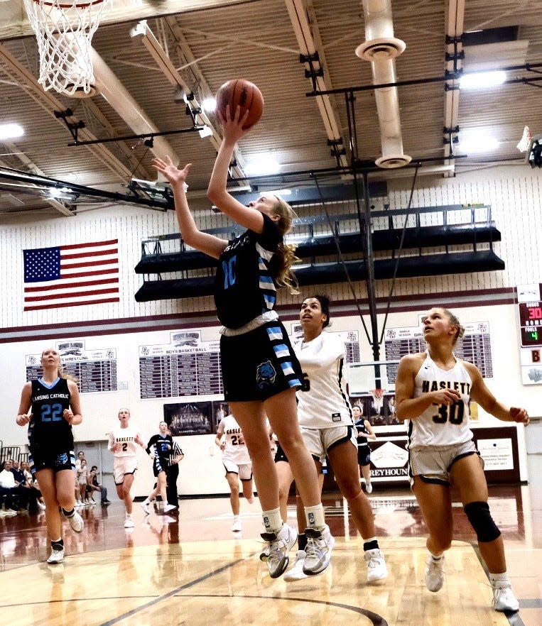 Lansing Catholic’s Anna Richards (10) makes a layup against Haslett during a Division 2 district final at Eaton Rapids High School on Saturday, Mar. 4, 2023.