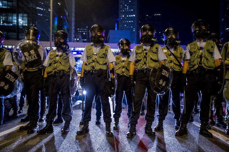 Police officers stand guard during overnight clashes with pro-democracy protesters in Hong Kong