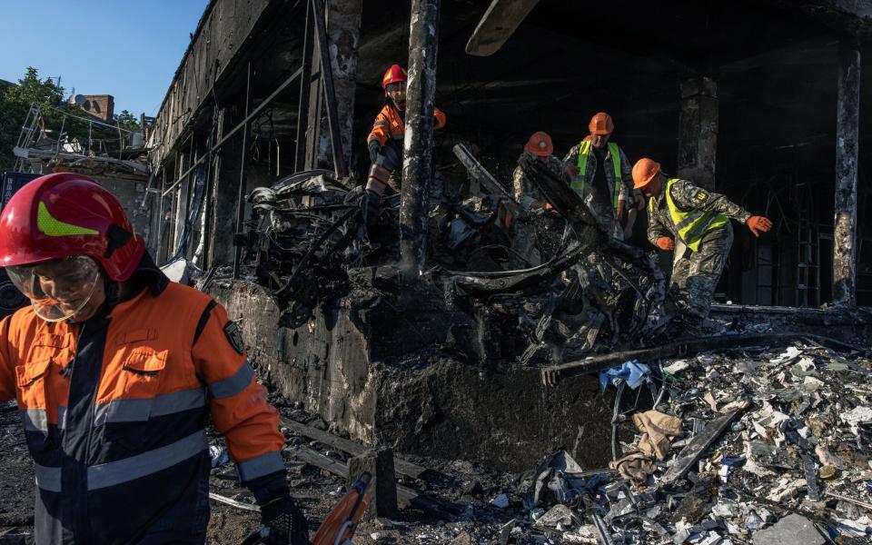 Ukrainian emergency workers and military work at the site of the Russian missile strike in downtown Vinnytsia - ROMAN PILIPEY/EPA-EFE/Shutterstock