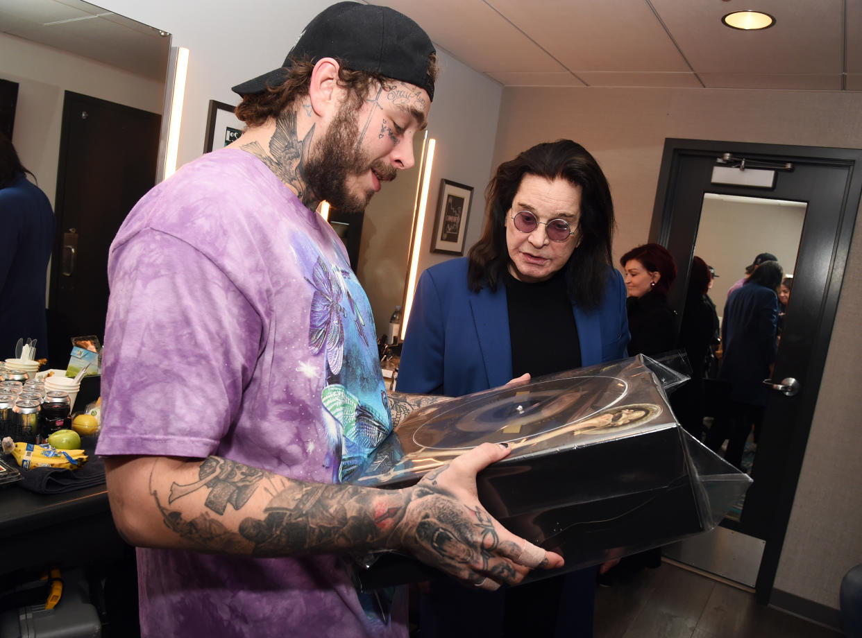 LOS ANGELES, CALIFORNIA - NOVEMBER 22: (L-R) Post Malone and Ozzy Osbourne are seen backstage during the 2019 American Music Awards Rehearsals at Microsoft Theater on November 22, 2019 in Los Angeles, California. (Photo by Kevin Winter/AMA2019/Getty Images for dcp)