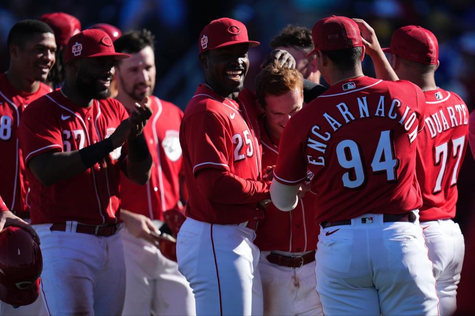 Reds players surround Matt McLain after he hit a walk-off home run to lead the Reds to a spring training win over the Cleveland Guardians. McLain is starting the season at Louisville, hoping to build on his impressive spring training.