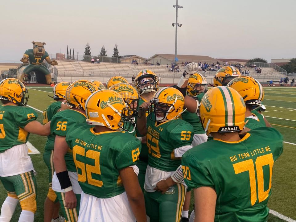 Tracy football gathers in a team huddle ahead of its game against Rocklin on Sept. 22, 2023 at Tracy High School.