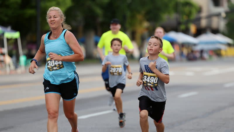 Lori Mahoney and Joshua Morgan run together in the Deseret News 5K in Salt Lake City on Friday, July 23, 2021. Participating in a local 5K is a great way to get in shape and engage with your community.