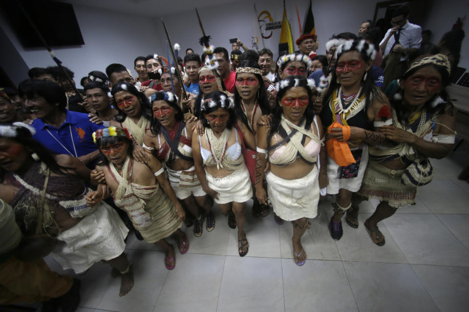 Waoranis dance in celebration after a judged ruled in their favor in a lawsuit filed against the Ministry of Non-Renewable Natural Resources for opening up oil concessions on their ancestral land, in Puyo, Ecuador, Friday, April 26, 2019. (AP Photo/Dolores Ochoa)