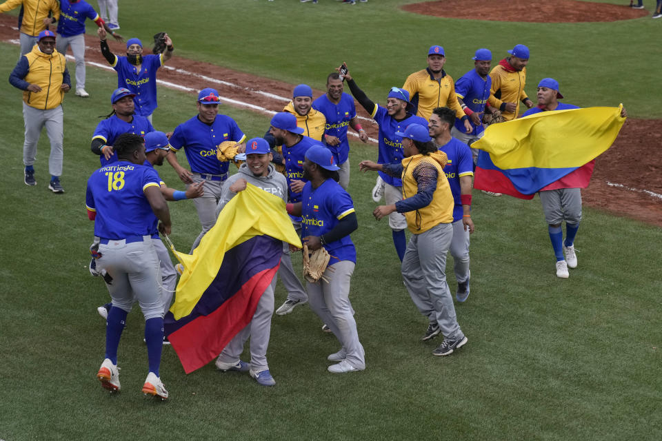 Colombia's baseball players celebrate their gold medal victory over Brazil, at the Pan American Games in Santiago, Chile, Saturday, Oct. 28, 2023. (AP Photo/Moises Castillo)
