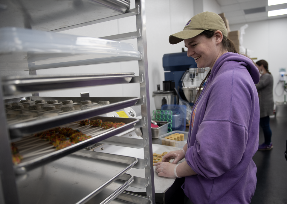 Michelle Cremi, the shop manager for Daisy Pops since 2018, punches the cake pop shape using a cookie cutter.