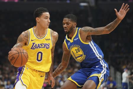 October 12, 2018; San Jose, CA, USA; Los Angeles Lakers forward Kyle Kuzma (0) dribbles the basektball against Golden State Warriors forward Alfonzo McKinnie (28) during the first quarter at SAP Center. Mandatory Credit: Kyle Terada-USA TODAY Sports