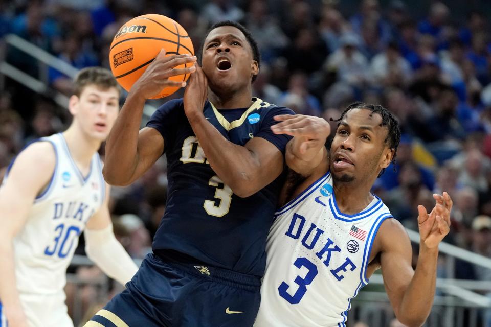 Oral Roberts guard Max Abmas draws a foul from Duke's Jeremy Roach during a first-round game in the NCAA Tournament last March. Abmas scored 2,562 career points for Oral Roberts but won just two NCAA Tournament games in four seasons at the school.