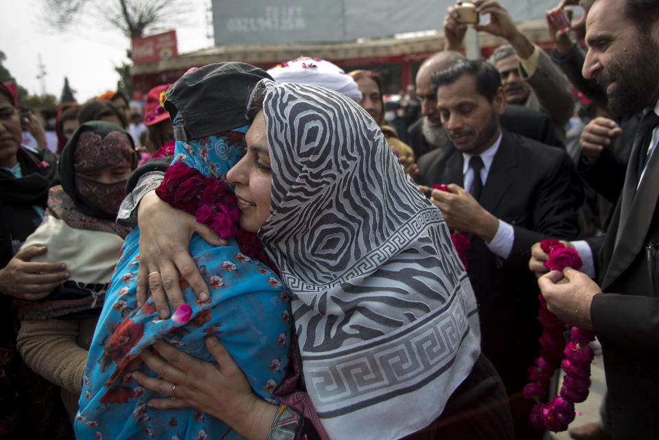 People welcome the family members of missing people during a march in Rawalpindi, Pakistan, Friday, Feb. 28, 2014. Affected families walked nearly 3,000 kilometers to reach capital Islamabad and register protest against the abductions and killings of their loved ones by Pakistani security agencies without producing them in court of law. (AP Photo/B.K. Bangash)