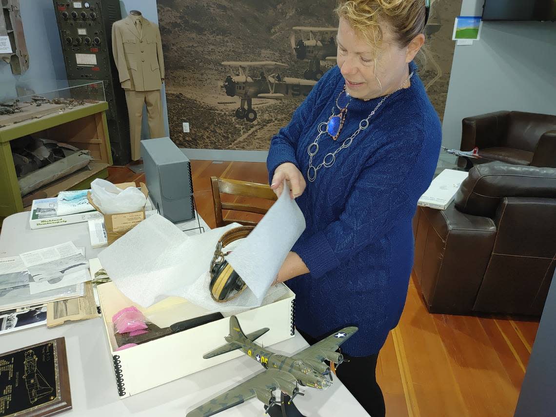 Malin Bergstrom, president of the Pasco Aviation Museum, displays goggles, a hatchet and other artifacts connected to Day’s Pay, the B-17 bomber constructed with donations from Tri-City workers during World War II.