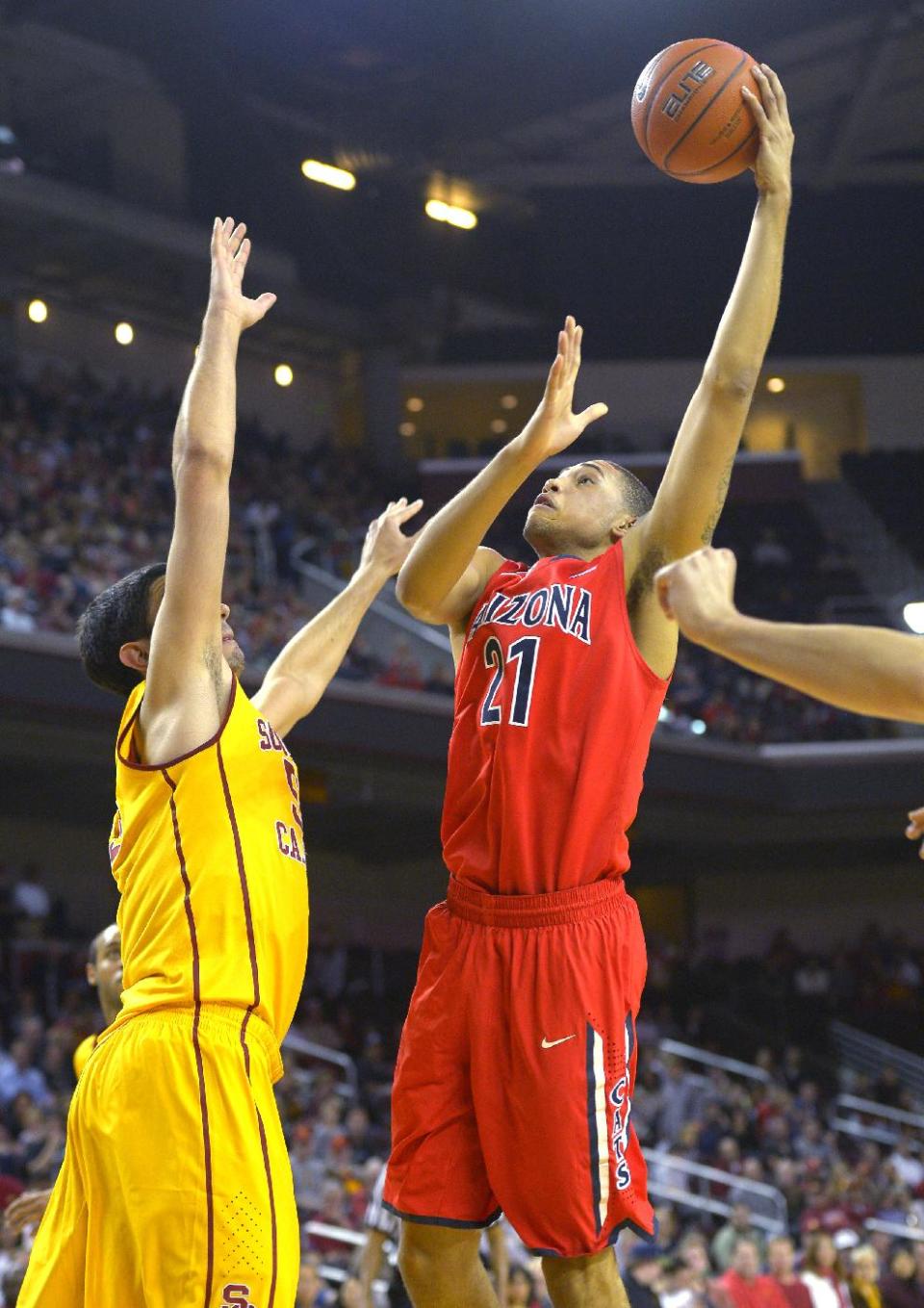 Arizona forward Brandon Ashley, right, puts up a shot as Southern California center Omar Oraby defends during the first half of an NCAA college basketball game, Sunday, Jan. 12, 2014, in Los Angeles. (AP Photo/Mark J. Terrill)